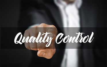 Eine Hand zeigt auf die Worte 'Quality Control', symbolisiert die Qualitätskontrolle durch BITMi für Dokumentenmanagement-Software.