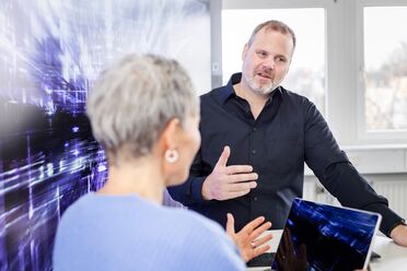 Zwei Personen diskutieren über die individuelle Anpassung von agorum core im Rahmen der 4Dev | CustomLab Schulung.